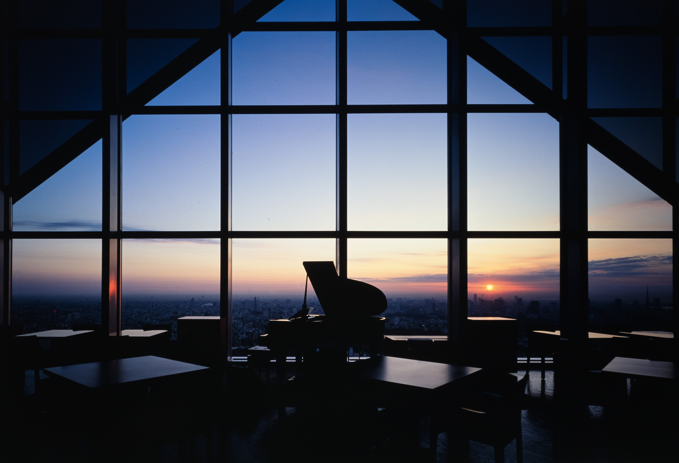 Grand piano at New York Bar, Park Hyatt Tokyo, overlooking the city at sunset