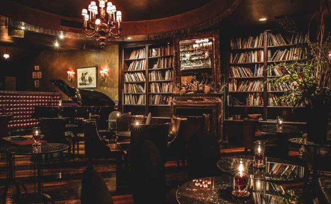 The piano and warmly lit wood interior of Tableaux Lounge in Daikanyama.