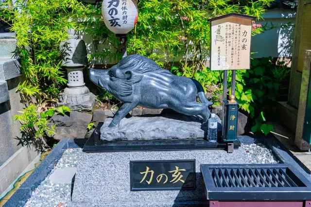 Boar statue beside a small shrine in Ameyoko
