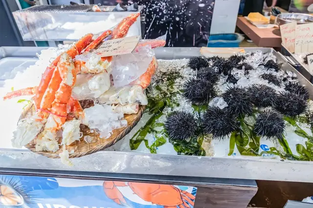 Crab and shellfish displayed on ice at Tsukiji