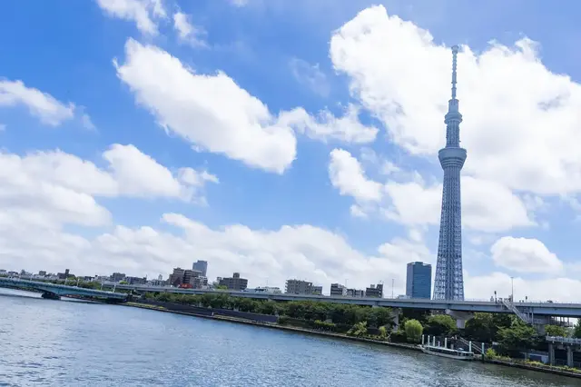 Tokyo Skytree rising above the Sumida River under a blue sky
