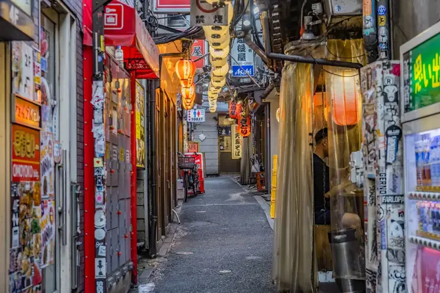 Narrow Shinjuku alley lined with signs and lanterns