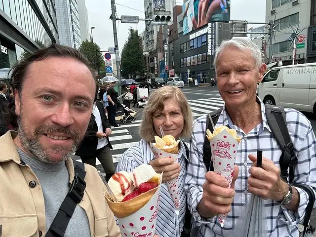 Renaud and guests holding crepes on a Tokyo street