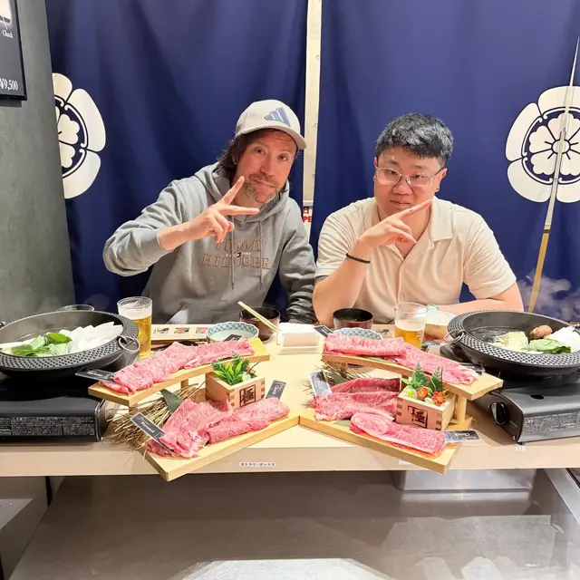Renaud and a guest at a Japanese restaurant table with individual hot pots