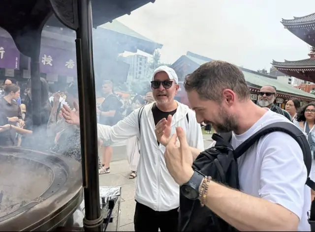Two guests by the incense burner at Sensō-ji temple in Asakusa