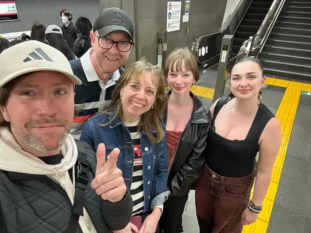 A Japan BTO guide and four guests smiling together at a Tokyo station