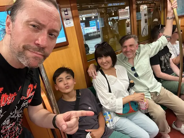 Renaud and guests inside a wood-panelled train carriage