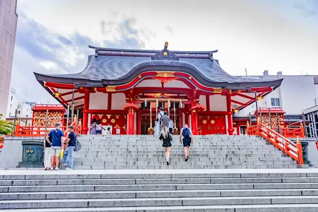 Red shrine building and stone steps in Shinjuku