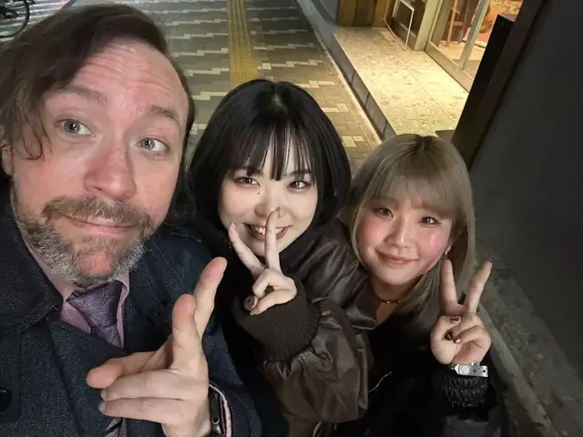 Out in Tokyo — a smile before the next stop.