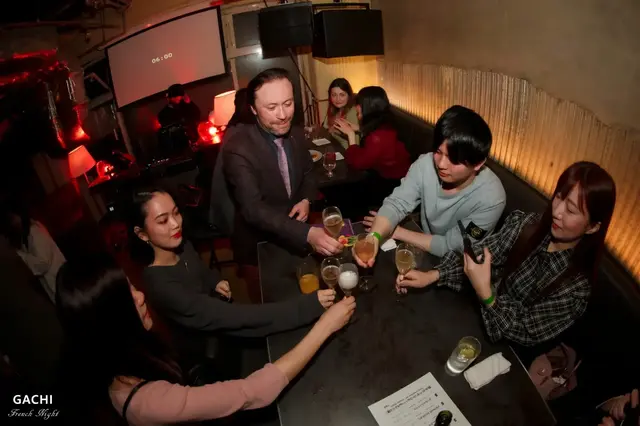 Around the table with Renaud — a shared toast to a Tokyo night together.
