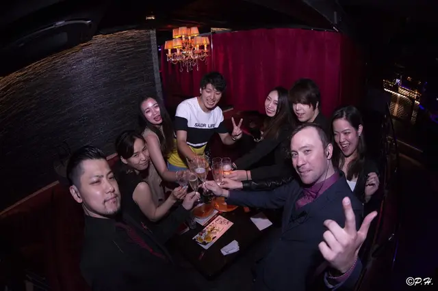 Renaud and guests raising their glasses in a lounge